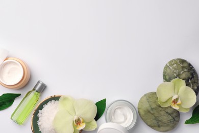 Photo of Flat lay composition with different spa products and beautiful flowers on white table. Space for text