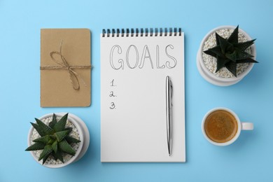 Photo of Planning concept. Flat lay composition with empty list of goals in notebook and coffee on light blue background