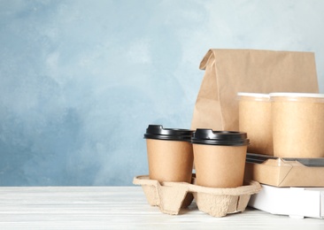 Various takeout containers on table, space for text. Food delivery service