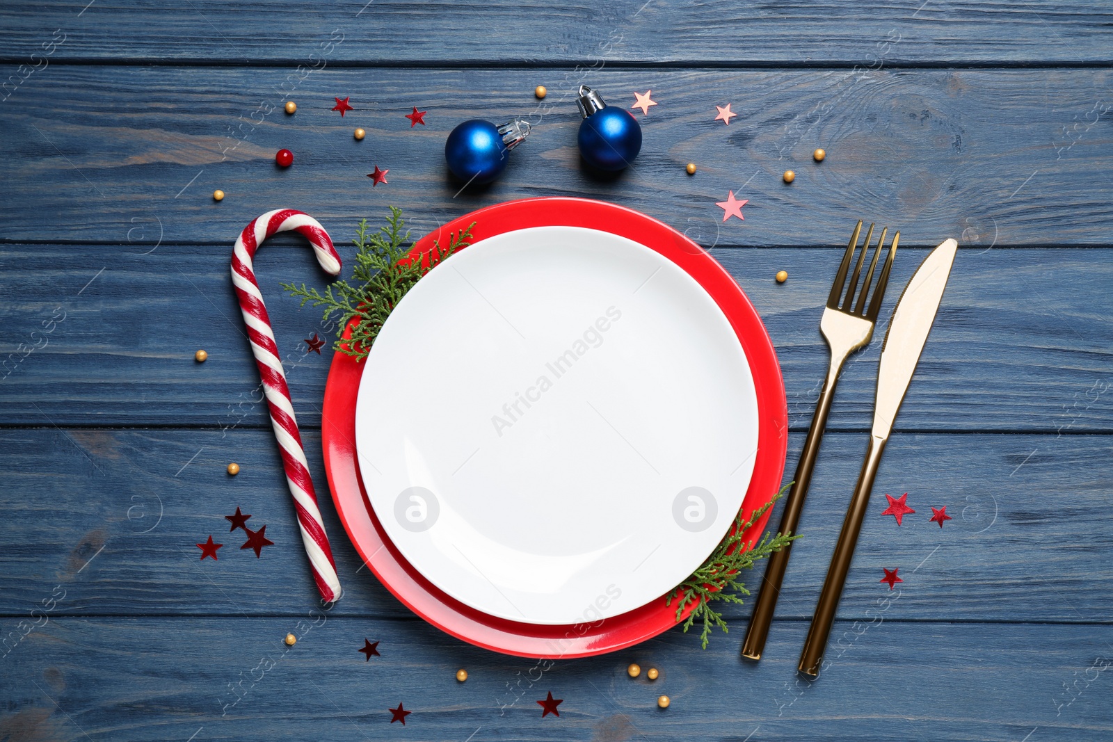 Photo of Beautiful Christmas table setting on blue wooden background, flat lay