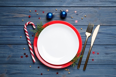 Beautiful Christmas table setting on blue wooden background, flat lay