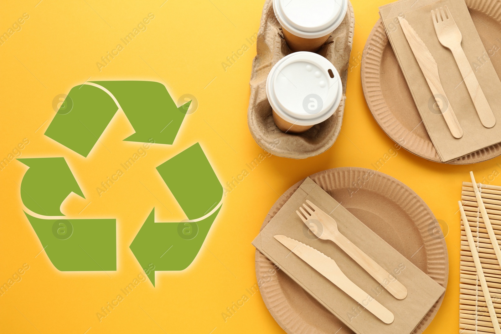 Image of Flat lay composition with eco friendly tableware and recycling symbol on yellow background