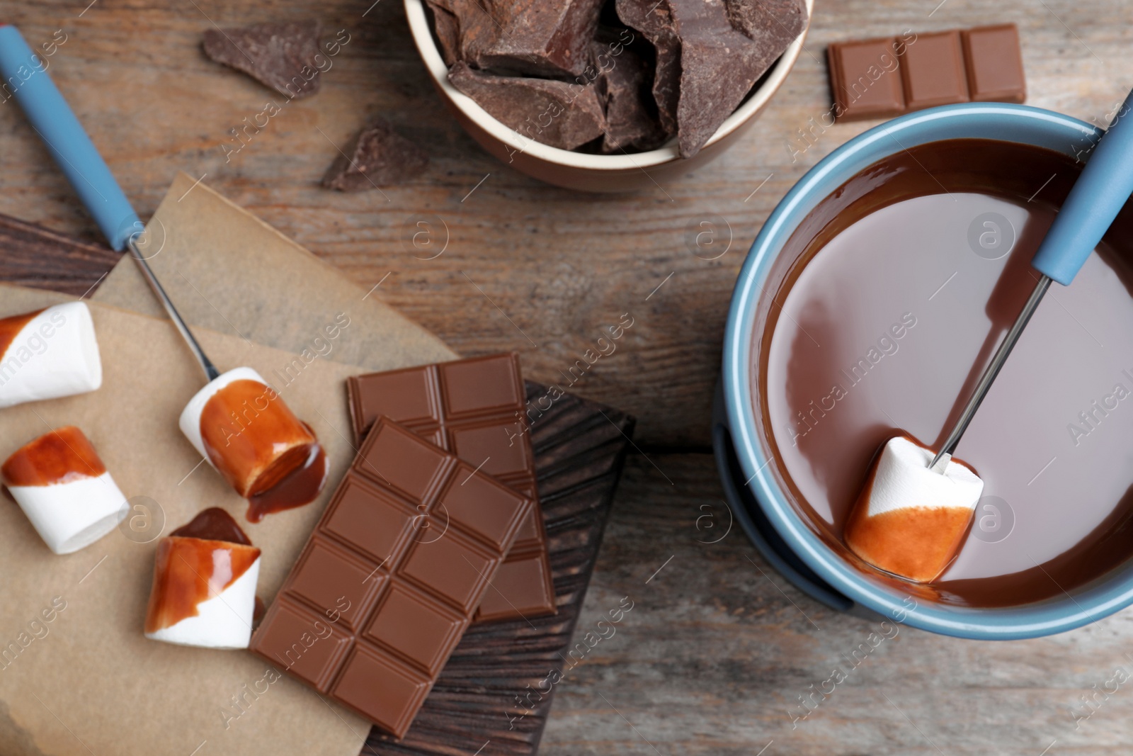 Photo of Flat lay composition with chocolate fondue on wooden background