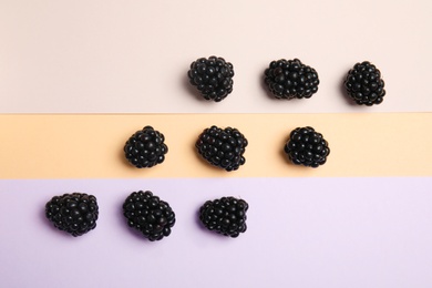 Photo of Flat lay composition with ripe blackberries on color background