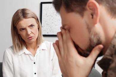 Psychologist working with military officer in office