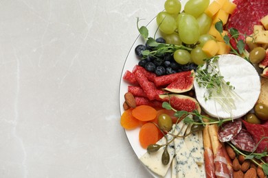 Photo of Set of different delicious appetizers served on light grey table, top view. Space for text