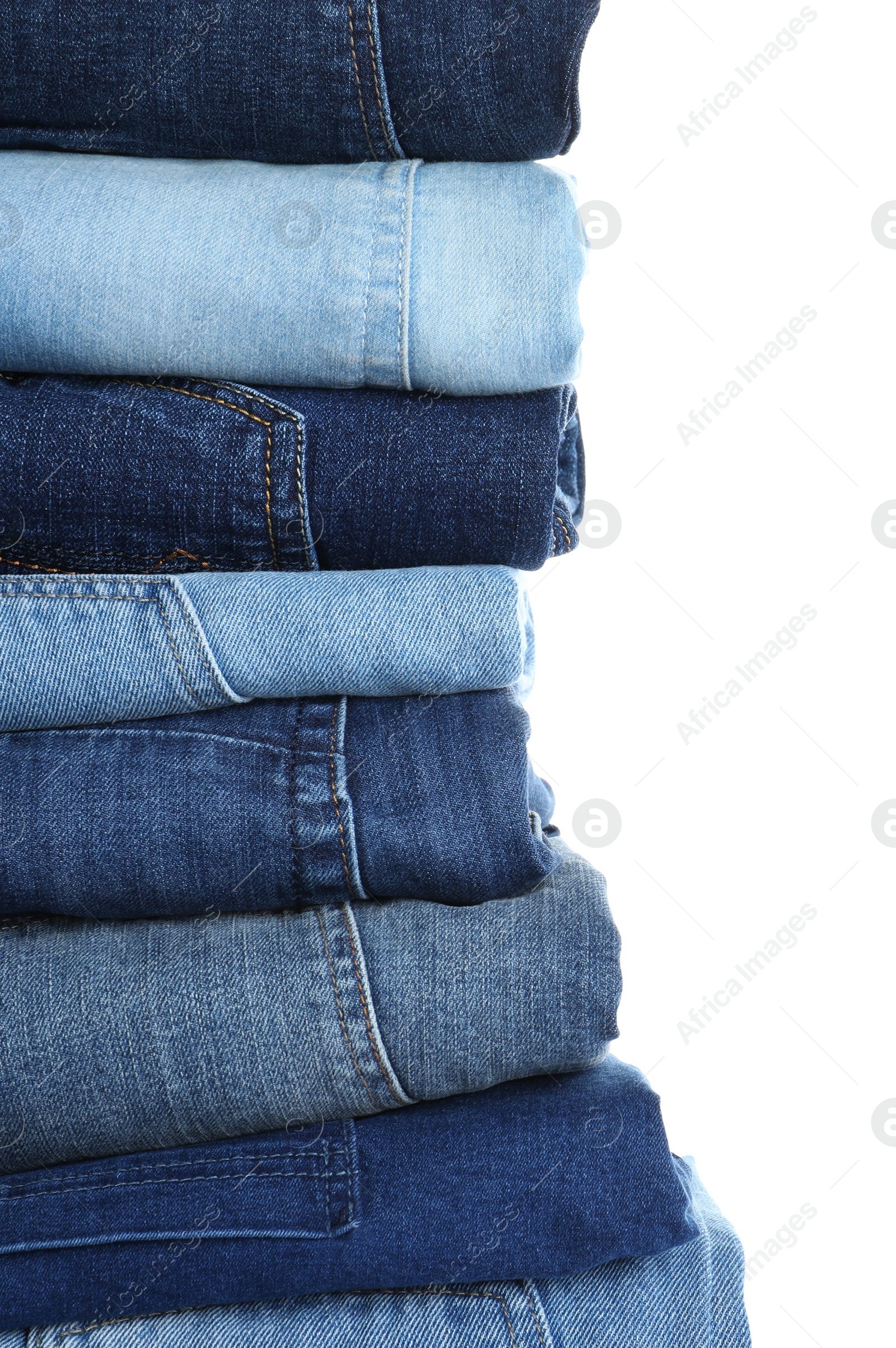 Photo of Stack of different jeans isolated on white