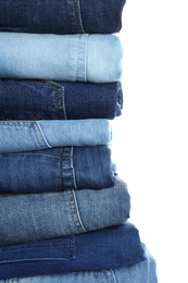 Stack of different jeans isolated on white