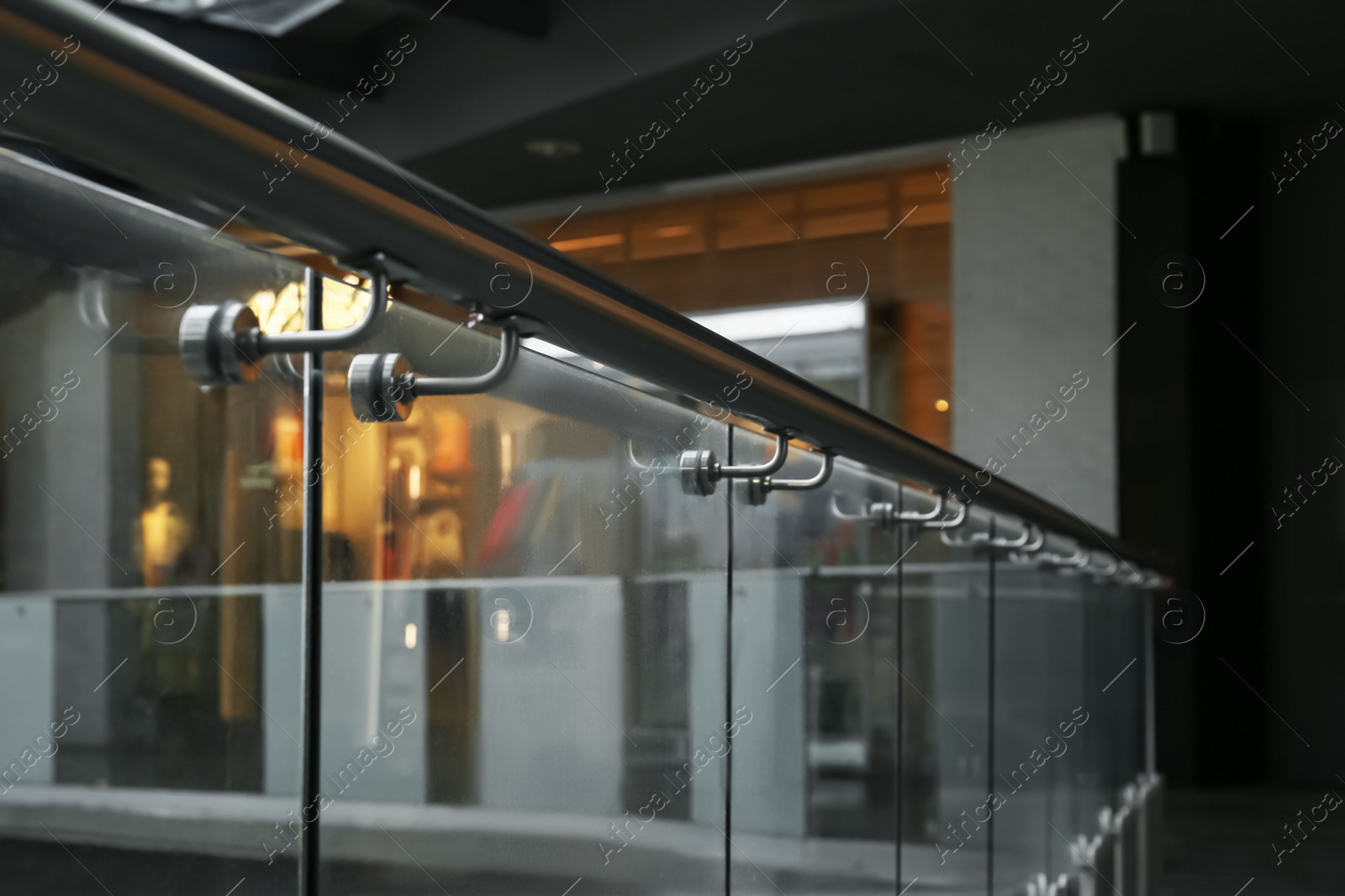 Photo of Glass barrier with metal handrail in modern building