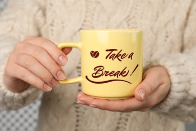 Woman holding mug with inscription Take a Break, closeup