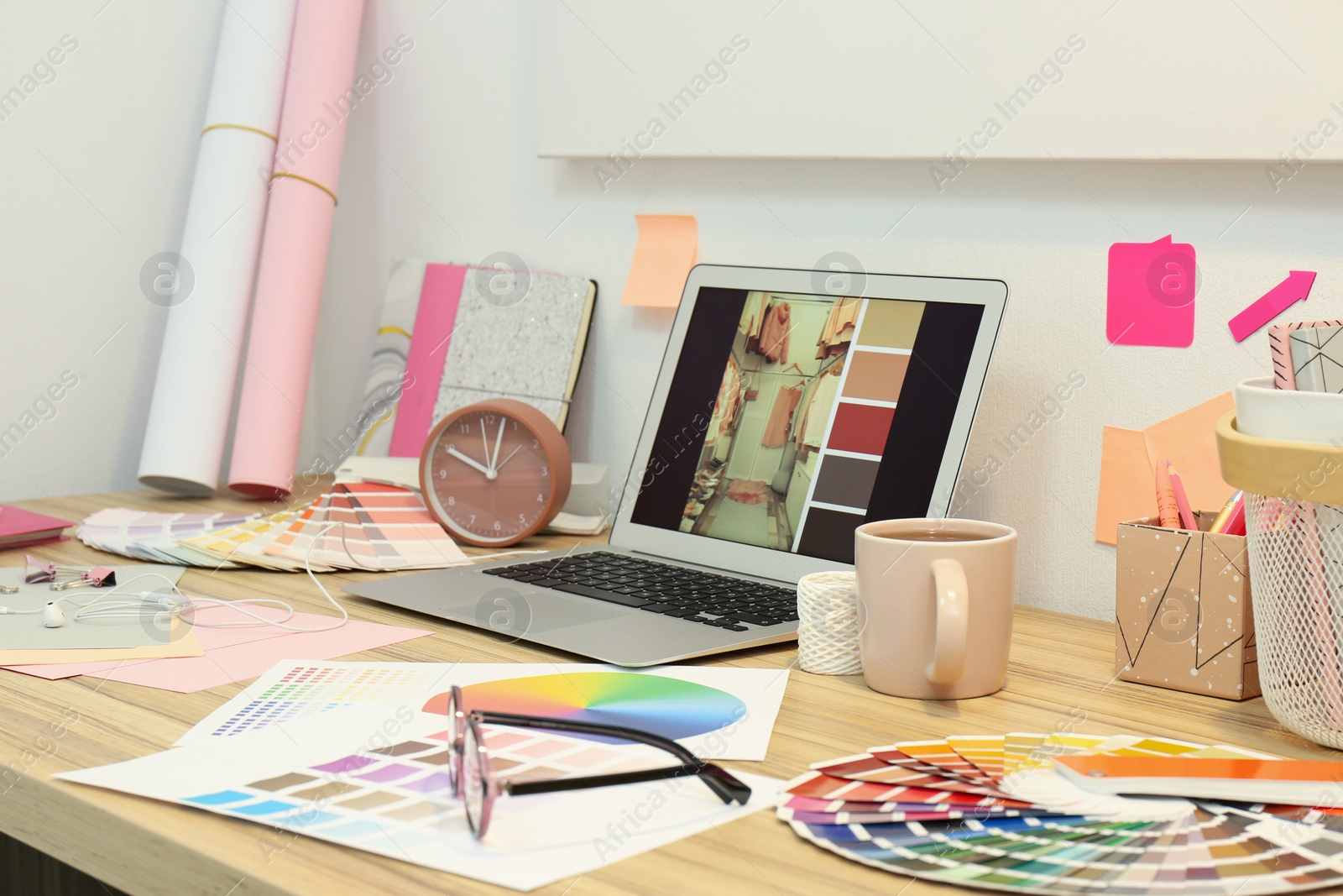 Photo of Designer's workplace with modern laptop and color palettes 