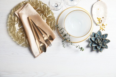 Photo of Elegant table setting and space for text on light background, top view