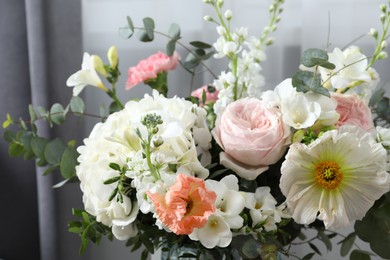 Bouquet of beautiful flowers on light background, closeup