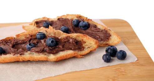 Tasty croissant with chocolate paste and blueberries on white background