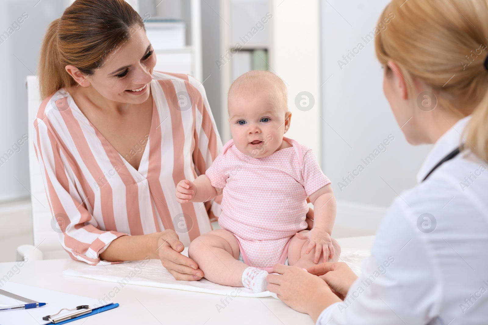 Photo of Woman with her baby visiting children's doctor in hospital