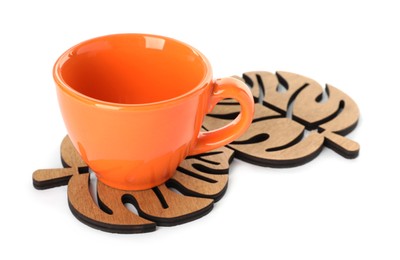 Photo of Leaf shaped wooden coasters and cup on white background