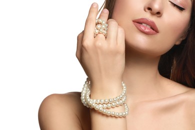 Photo of Young woman with elegant pearl necklace on white background, closeup