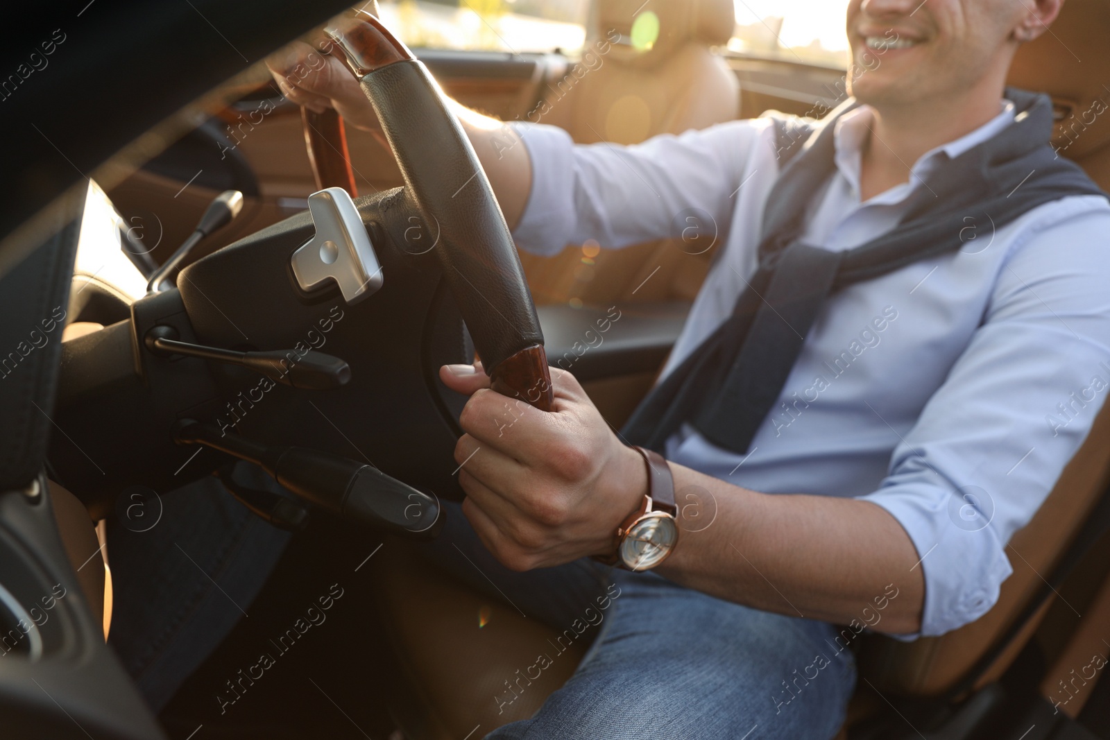 Photo of Stylish man driving luxury convertible car, closeup