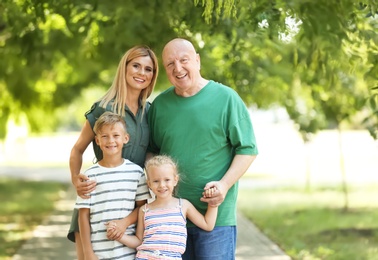 Woman with children and elderly father in park