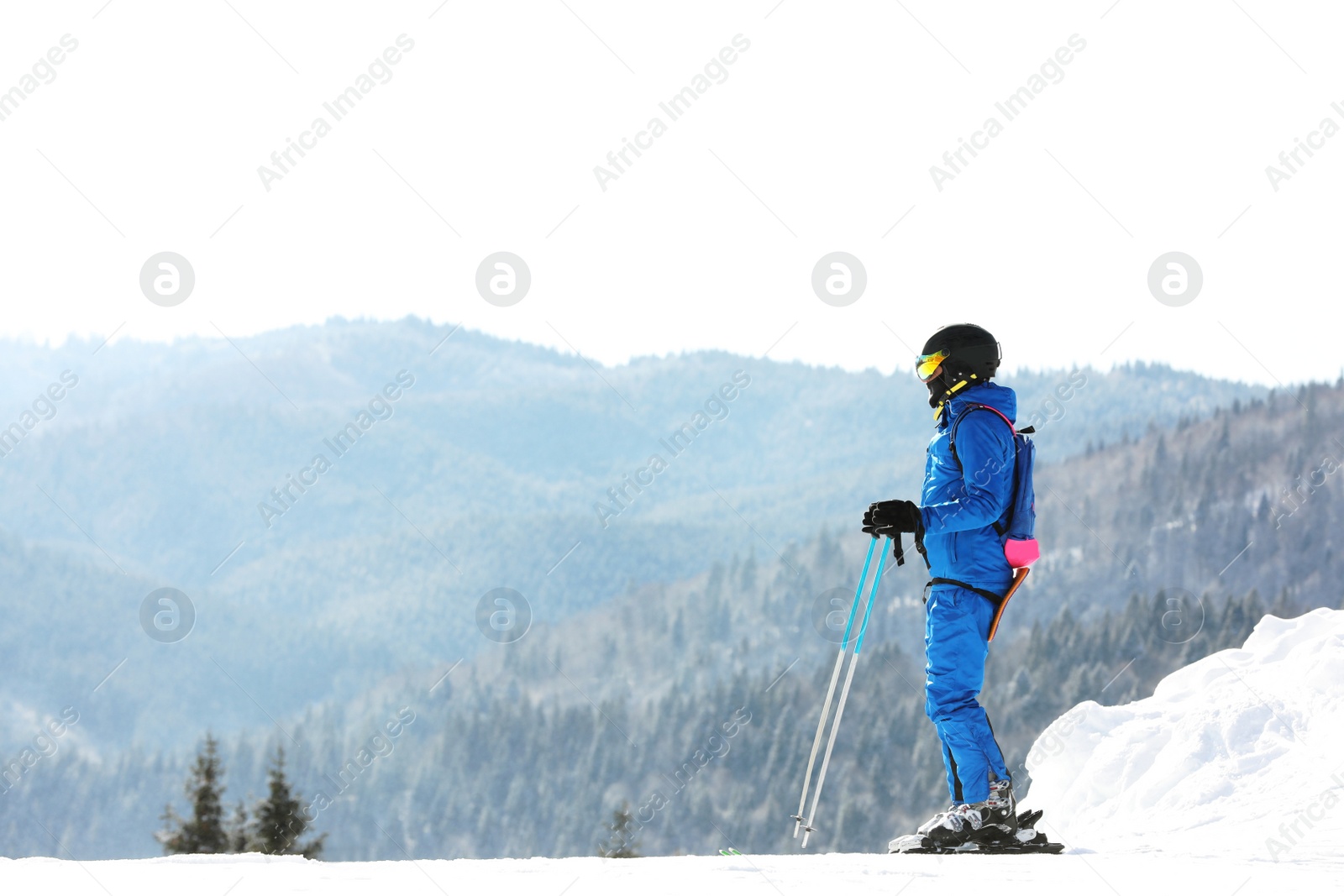 Photo of Man skiing on snowy hill in mountains, space for text. Winter vacation