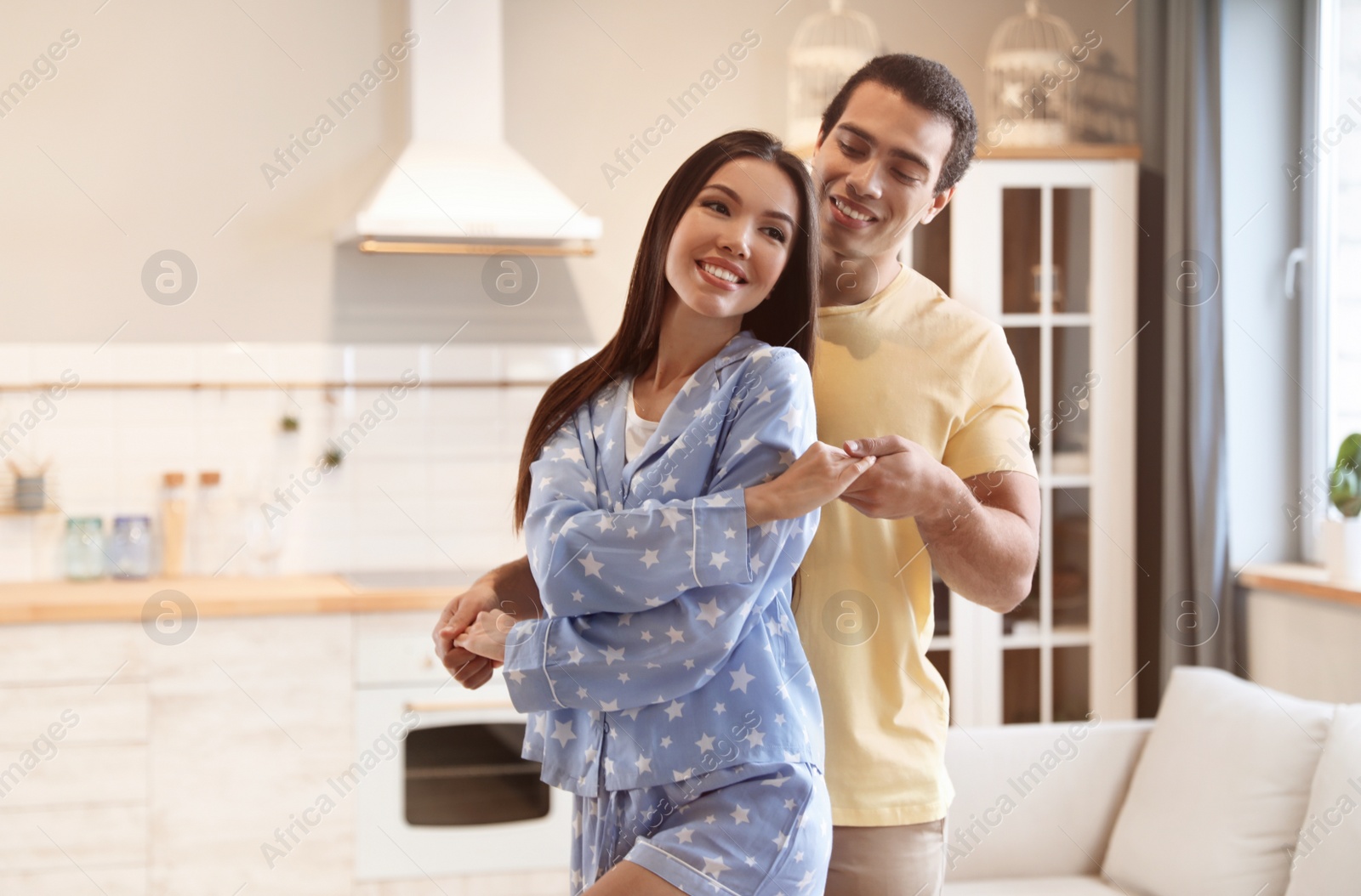 Photo of Lovely young interracial couple dancing at home