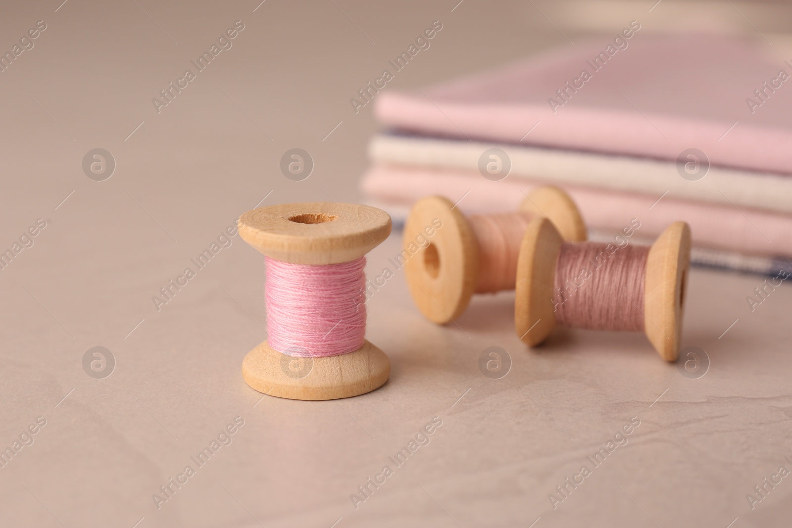 Photo of Set of color sewing threads on light grey table