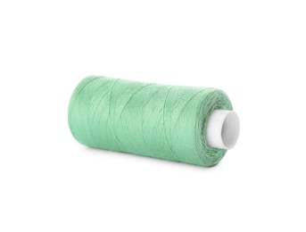 Photo of Spool of light green sewing thread isolated on white