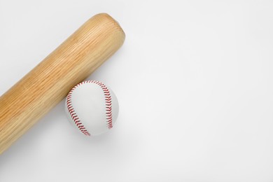 Photo of Wooden baseball bat and ball on white background, top view with space for text. Sports equipment