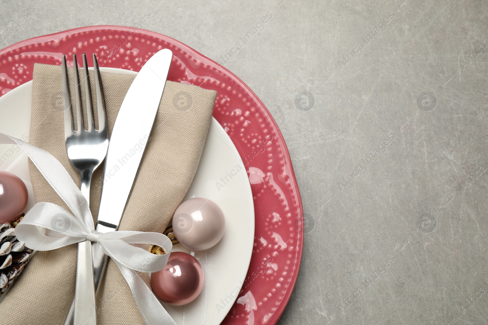 Photo of Festive table setting with beautiful dishware and Christmas decor on grey background, top view. Space for text