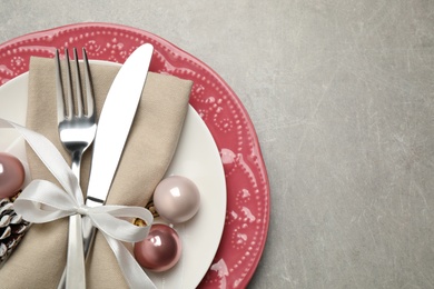 Festive table setting with beautiful dishware and Christmas decor on grey background, top view. Space for text