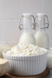 Photo of Dairy products. Fresh cottage cheese and milk on table, closeup