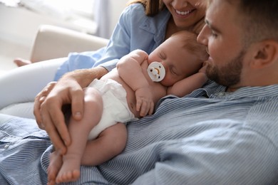 Photo of Happy couple with their newborn baby, closeup