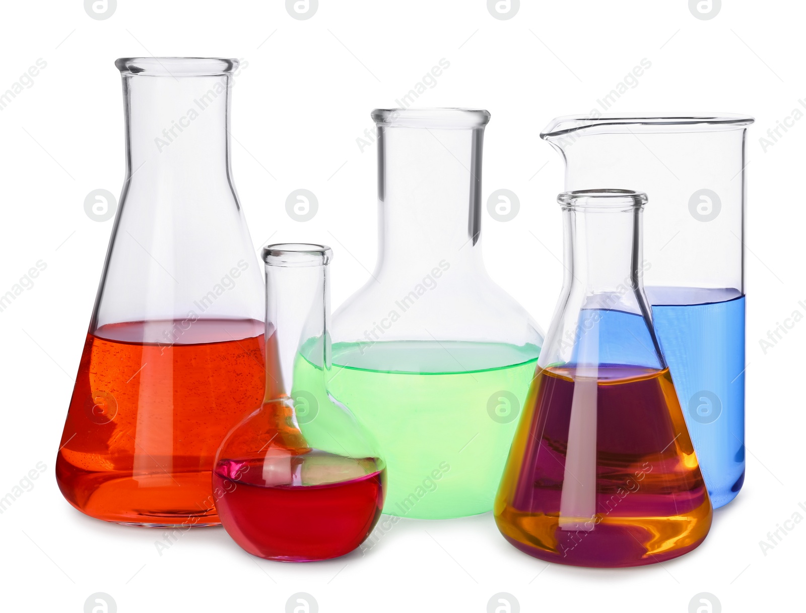 Photo of Different laboratory glassware with colorful liquids on white background