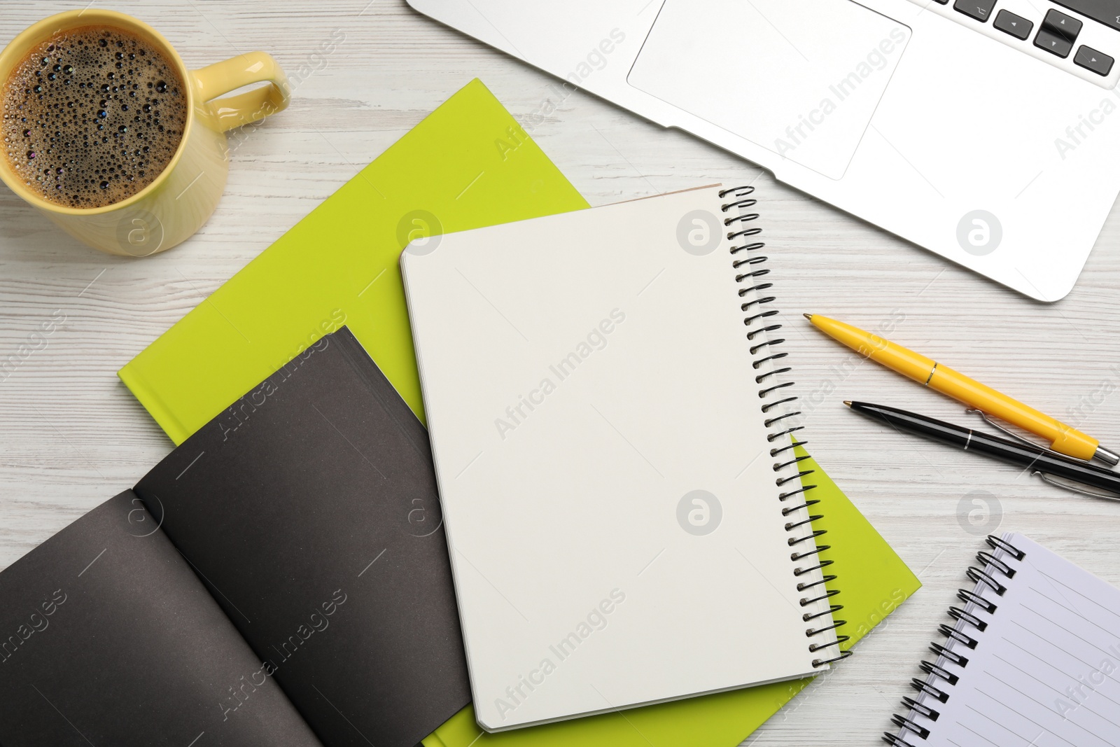 Photo of Flat lay composition with different notebooks, coffee and pens on wooden table