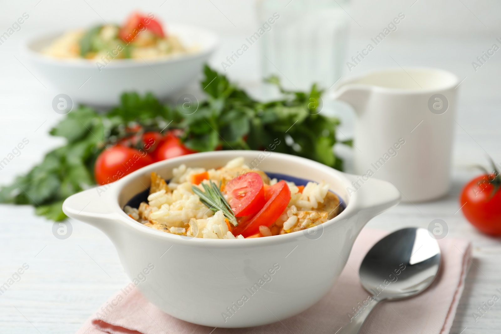 Photo of Delicious chicken risotto served in bowl on table