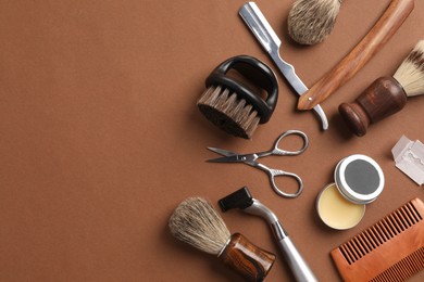 Photo of Moustache and beard styling tools on brown background, flat lay. Space for text