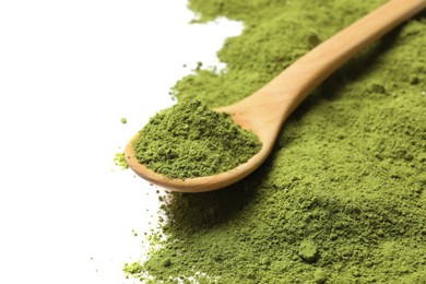 Photo of Green matcha powder and wooden spoon isolated on white