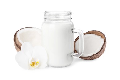 Photo of Mason jar of delicious vegan milk, coconut and flower on white background