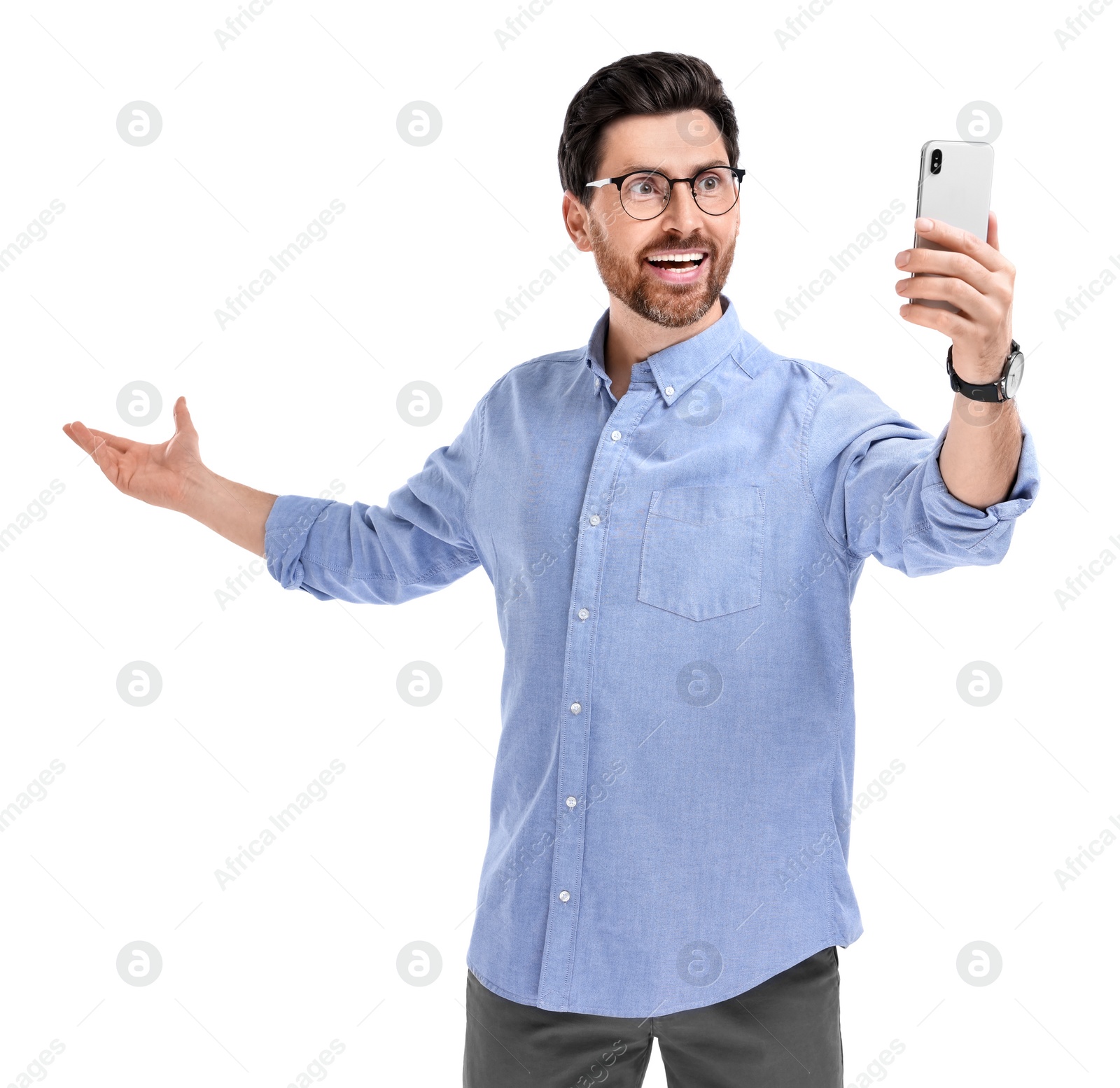 Photo of Smiling man taking selfie with smartphone on white background