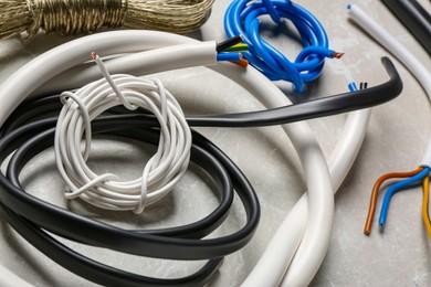 Different electrical wires on light grey table, closeup