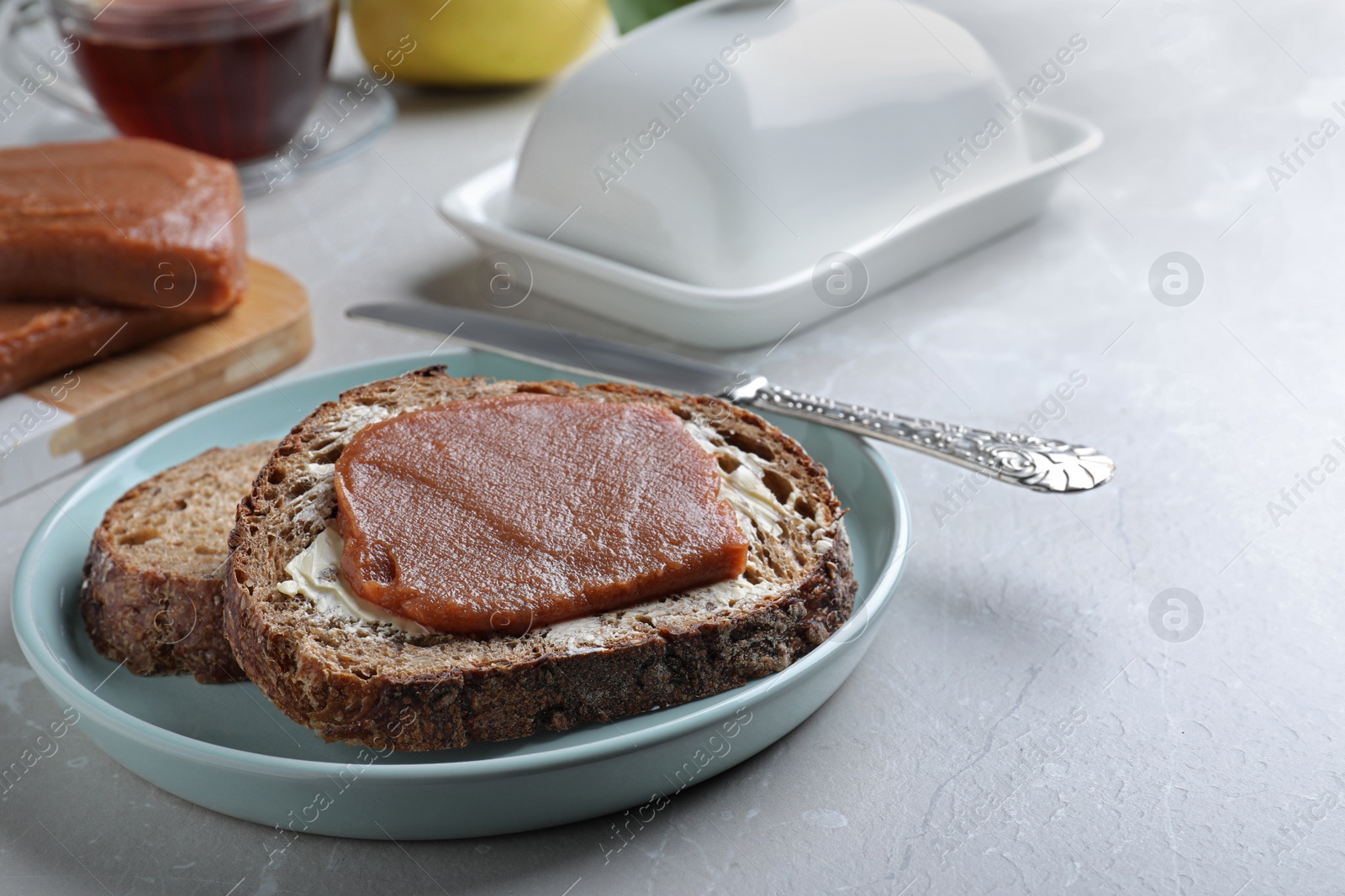 Photo of Tasty sandwich with quince paste served for breakfast on light table