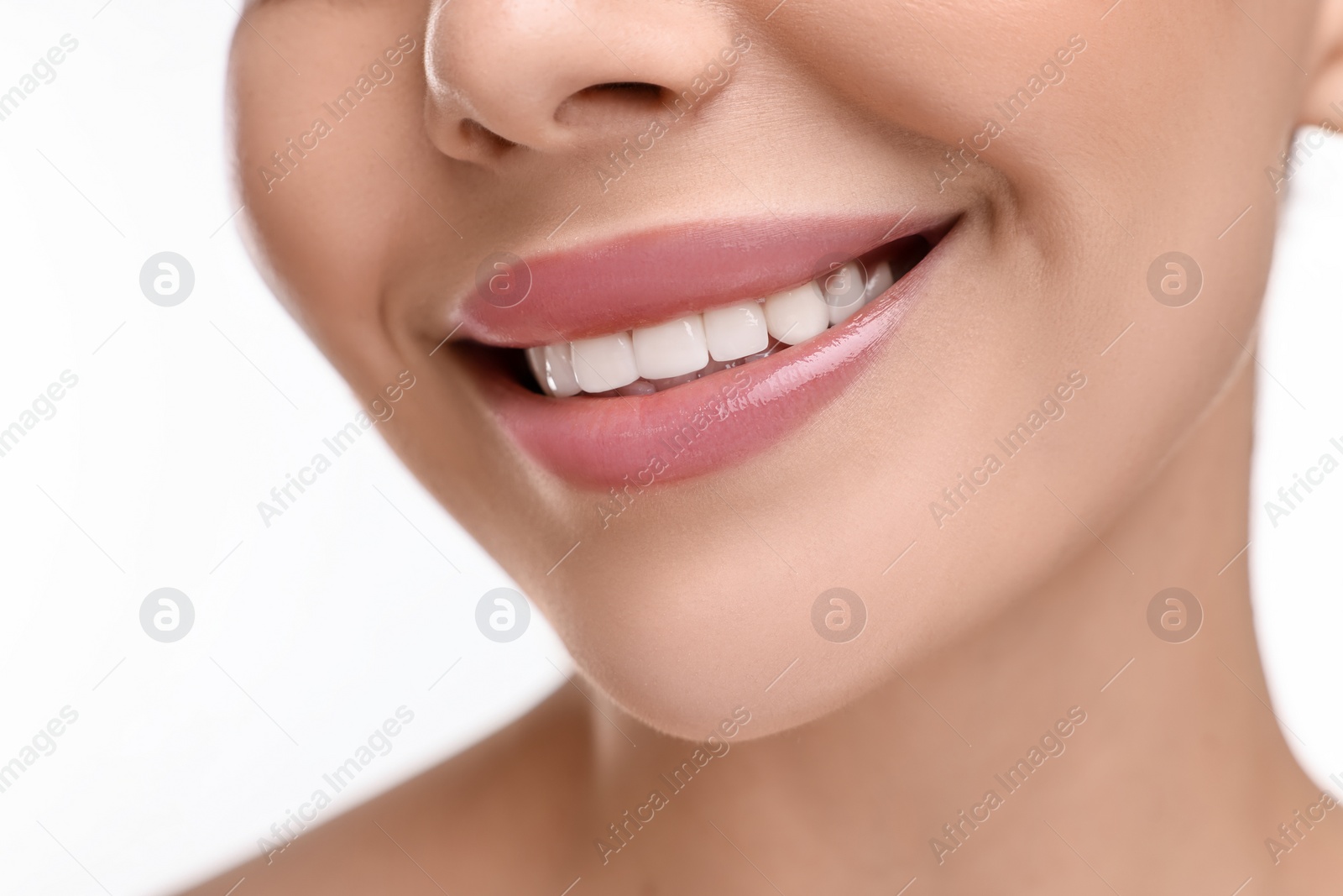 Photo of Woman with beautiful lips smiling on white background, closeup