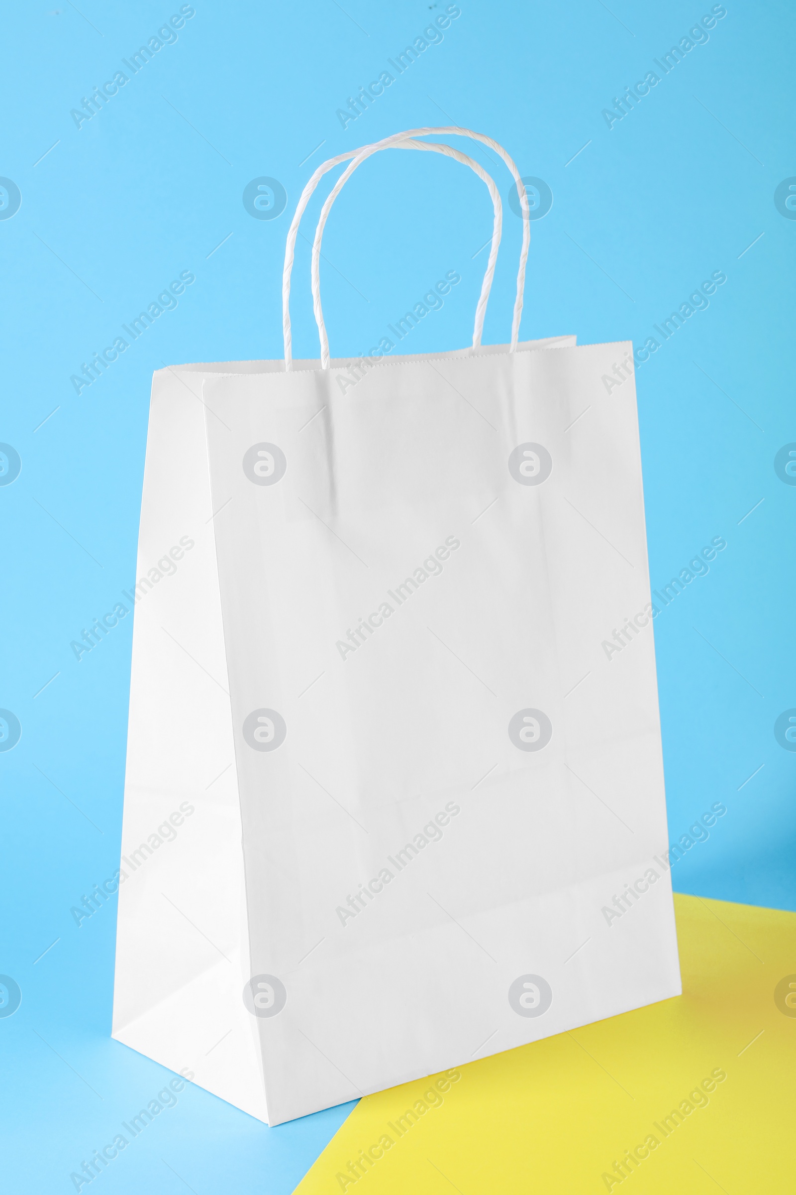 Photo of One paper bag on color background, space for text