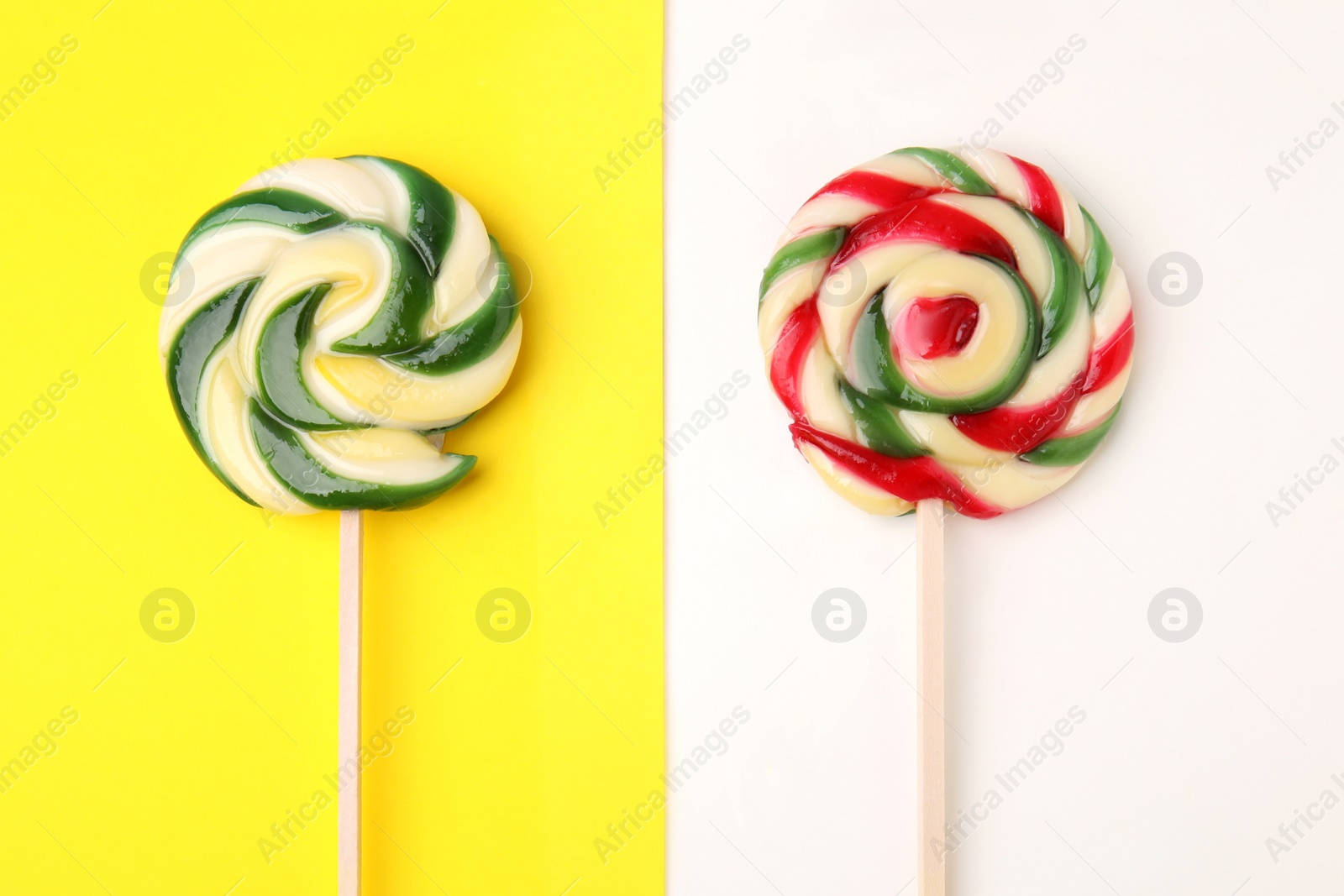 Photo of Sweet lollipops on color background, flat lay