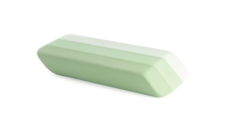 Photo of New bright eraser isolated on white. School stationery