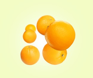 Image of Fresh ripe oranges flying on cream background