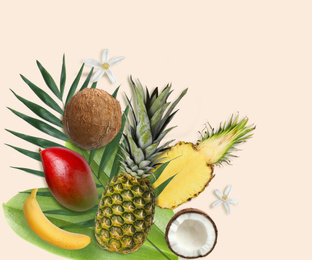 Image of Tropical layout with fresh exotic fruits and green leaves on pale beige background, top view