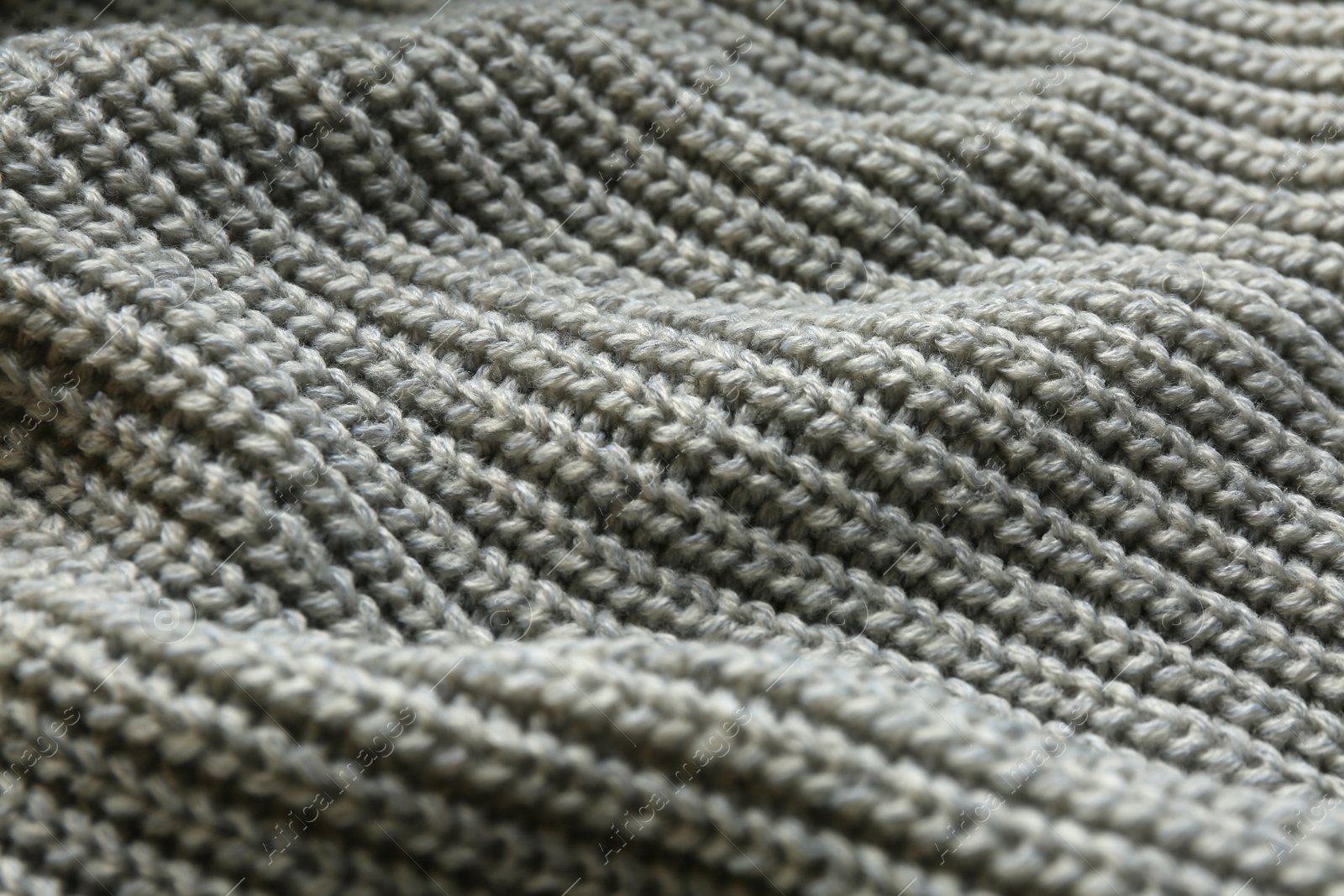 Photo of Beautiful grey knitted fabric as background, closeup