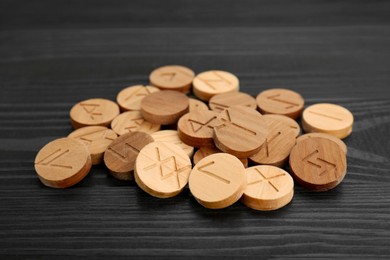 Pile of runes on black wooden table