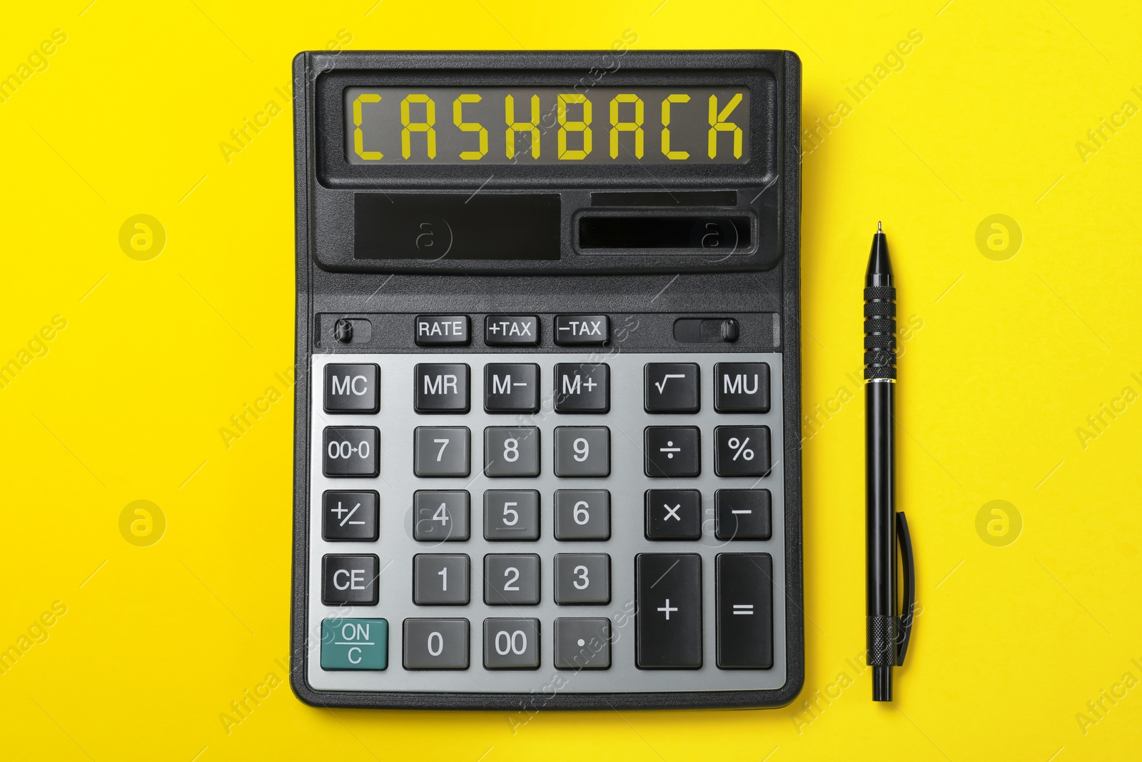 Image of Calculator with word Cashback and pen on yellow background, top view